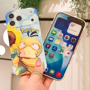 May include: Two phone cases. One case features a cartoon Psyduck character holding a sunflower, with the text "Pok&eacute;mon". The other phone displays the home screen with app icons and the date.