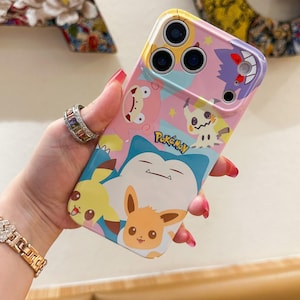 May include: A colorful phone case featuring various Pok&eacute;mon characters, including Pikachu, Eevee, and Snorlax. The case has a pink, blue, and yellow background with the "Pok&eacute;mon" logo. The case is designed to fit a smartphone.