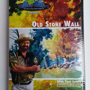 May include: DVD cover featuring a painting of an old stone wall with trees in the background. The artist, Tom Jones, is pictured on the cover holding paintbrushes. The text on the cover reads "The World of Art Presents Old Stone Wall with Tom Jones. Recommended for all skill levels."