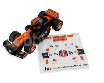 May include: A black and orange toy race car with the number 4 on the side, and a sheet of stickers. The car has black wheels and orange accents. The sticker sheet has the text "hb Custom Stickers Mini MCL39 - 2025".