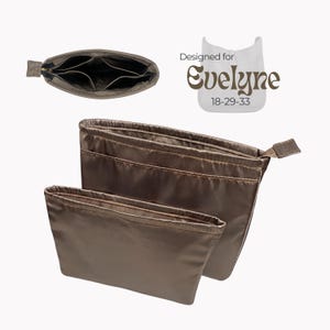 May include: Bronze-colored organizer inserts for handbags. The image shows two sizes of inserts, one with multiple interior pockets and a zippered closure. The text "Designed for Evelyne 18-29-33" is also visible.