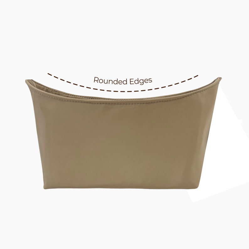 May include: A beige makeup bag with rounded edges. The bag is made of a soft, smooth fabric.