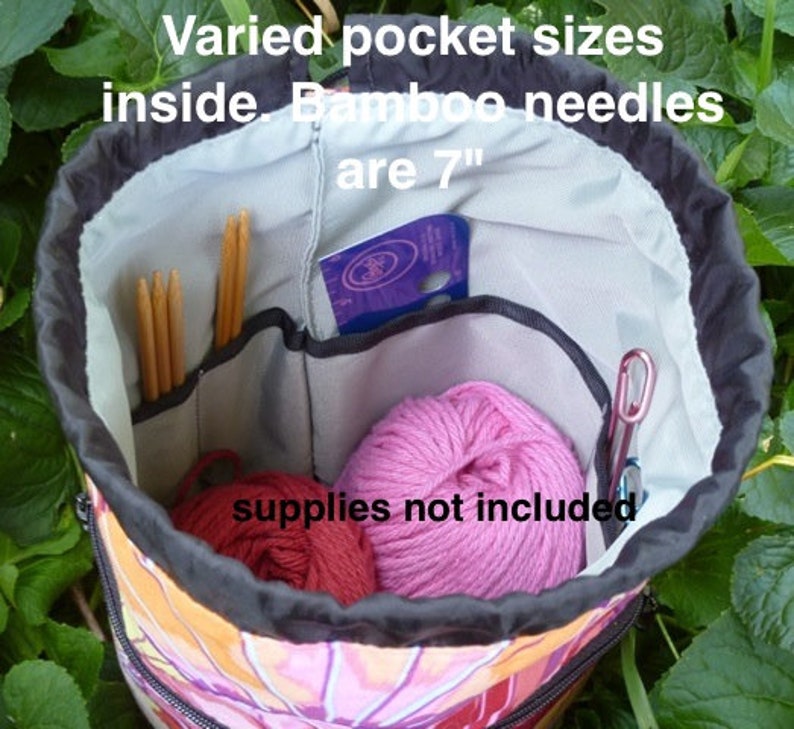 May include: A colorful drawstring bag with multiple pockets inside. The bag is open, revealing a variety of compartments and supplies, including bamboo knitting needles that are 7 inches long. "Varied pocket sizes inside. Bamboo needles are 7" "
