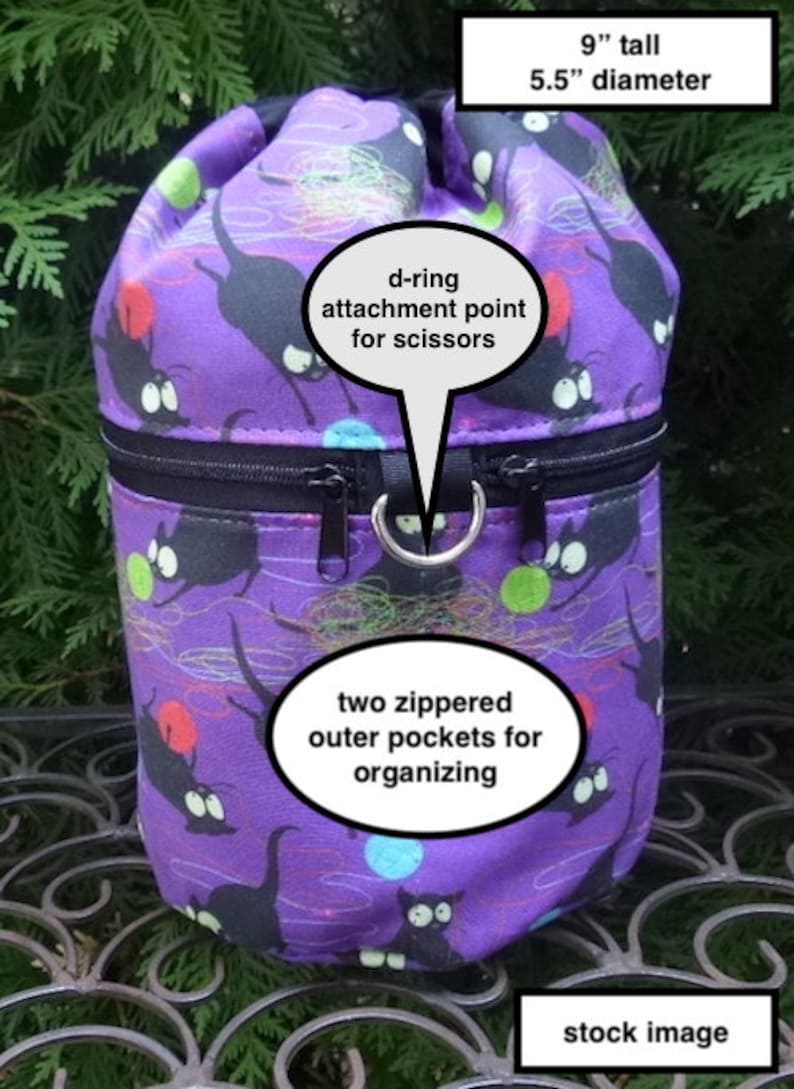 May include: Purple drawstring bag with a black cat print and two zippered outer pockets. The bag is 9 inches tall and 5.5 inches in diameter. It has a d-ring attachment point for scissors.  "stock image" is written at the bottom of the image.
