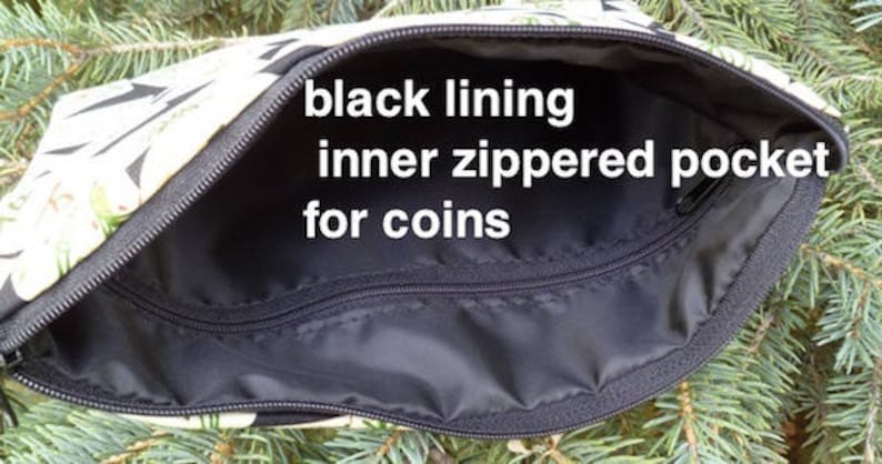 May include: Open view of a zippered pouch with a black interior and an inner zippered pocket. The pouch has a black zipper and a patterned exterior with black and white leaf designs. Text on the image reads: "black lining inner zippered pocket for coins."