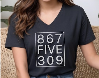 May include: Black V-neck t-shirt with a white graphic of the numbers 867, FIVE, and 309 in a box.