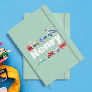 Peut inclure: Un carnet vert avec le nom "Henry" en blanc et des illustrations colorées de véhicules, dont un camion, une grue, une voiture et une maison.