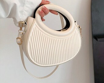 French-inspired trendy handbag, black/white. Striped pattern, embossed details, round crossbody, double handle