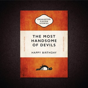 May include: A book cover with a red and orange background. The title is "The Most Handsome of Devils" and the subtitle is "Happy Birthday". The book cover also includes the text "Non Fiction" and a small illustration of a bird.