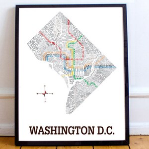 May include: A black framed print of a map of Washington D.C. The map is made up of words and the streets are highlighted in different colors. The words are in a white font and the background is white.