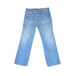 May include: Light blue denim jeans featuring a classic five-pocket design, a button fly closure, and a straight-leg cut. The fabric displays a consistent, faded wash throughout, with visible stitching along the seams and pockets.