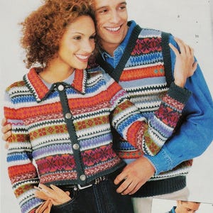 May include: A couple wearing colorful striped sweaters. The woman is wearing a cardigan with a collared neckline and the man is wearing a sleeveless sweater vest.
