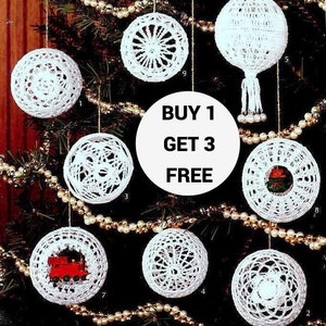 May include: Nine crochet snowball ornament designs, including a train, a star, and a snowflake. The ornaments are white and hang from a Christmas tree. The text "BUY 1 GET 3 FREE" is displayed on a red and white tag.