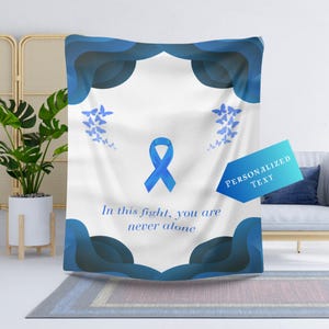 May include: Blue and white throw blanket with a blue ribbon and butterflies. The text "In this fight, you are never alone" is printed on the blanket.