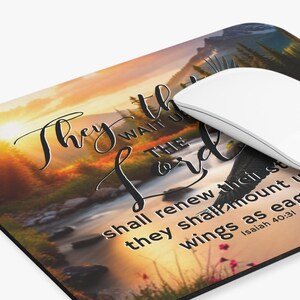 May include: A mouse pad with a scenic sunset landscape and a quote from Isaiah 40:31, "They that wait upon the Lord shall renew their strength; they shall mount up with wings as eagles..."