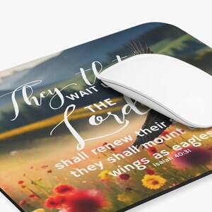 May include: A mouse pad with a colorful floral field and a mountain range in the background. The text "They that wait on the Lord shall renew their strength; they shall mount up with wings as eagles... Isaiah 40:31" is printed on the mouse pad.