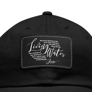 May include: Black baseball cap with a white patch that reads "Living Water" and a quote from the Bible attributed to Jesus.