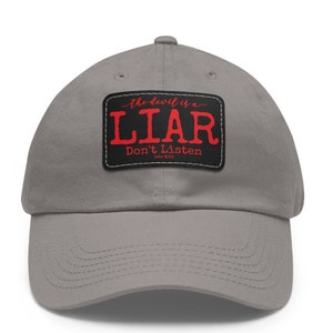 May include: Gray baseball cap with a black and white patch that says "The devil is a LIAR Don't Listen John 8:44".