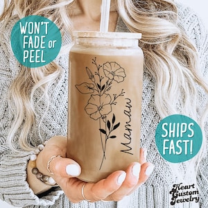 May include: A brown reusable tumbler with a floral design and the word "Mamaw" written on it.
