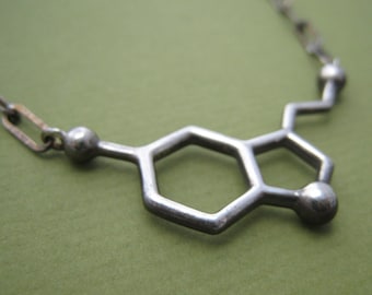 serotonin molecule necklace, styled for men