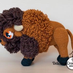 DeliciousCrochet American Bison (Buffalo). This is a crochet pattern, not the finished toy. Using DK or Sports acrylic yarn with a 2.5 mm hook, the toy stands 7.5 inches tall and 9 inches long. Instructions available in English (US) or Spanish.