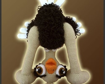 May include: A crocheted stuffed ostrich toy standing on its head with its legs in the air. The ostrich is beige with brown feathers and large black eyes.