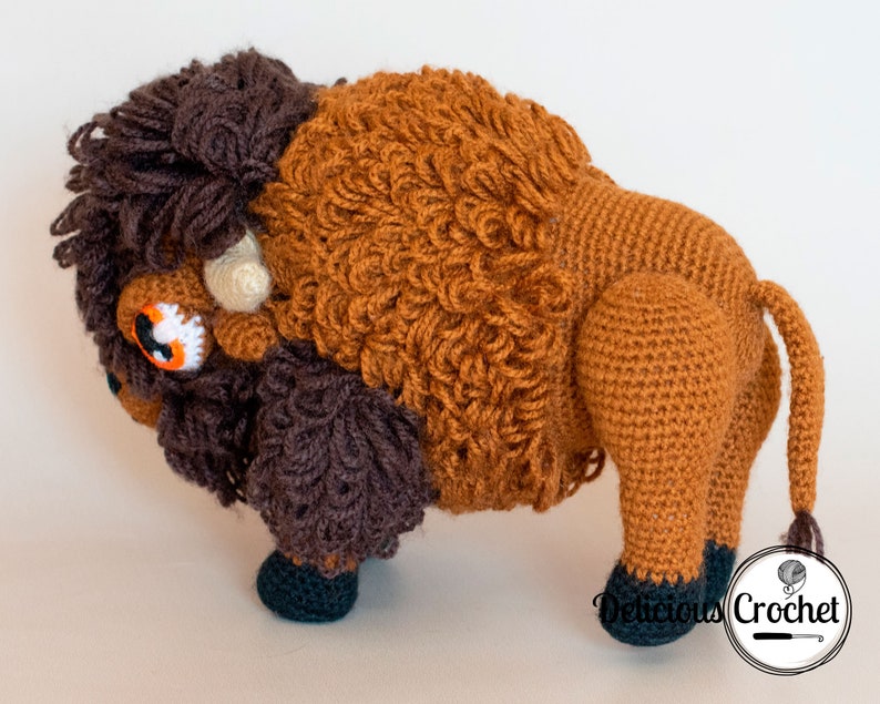 DeliciousCrochet American Bison (Buffalo). This is a crochet pattern, not the finished toy. Using DK or Sports acrylic yarn with a 2.5 mm hook, the toy stands 7.5 inches tall and 9 inches long. Instructions available in English (US) or Spanish.