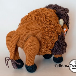 DeliciousCrochet American Bison (Buffalo). This is a crochet pattern, not the finished toy. Using DK or Sports acrylic yarn with a 2.5 mm hook, the toy stands 7.5 inches tall and 9 inches long. Instructions available in English (US) or Spanish.