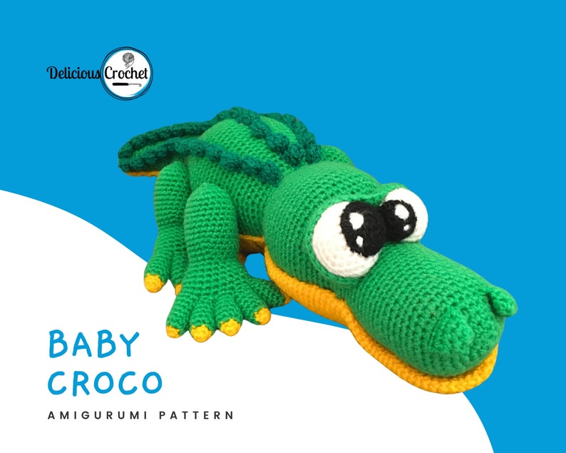 DeliciousCrochet Baby Croco. This is a crochet pattern, not the finished toy. Using DK or Sports acrylic yarn with a 2.5 mm hook, the croco is 16 inches long. Baby cap and pacifier are removable. Instructions available in English (US) or Spanish.