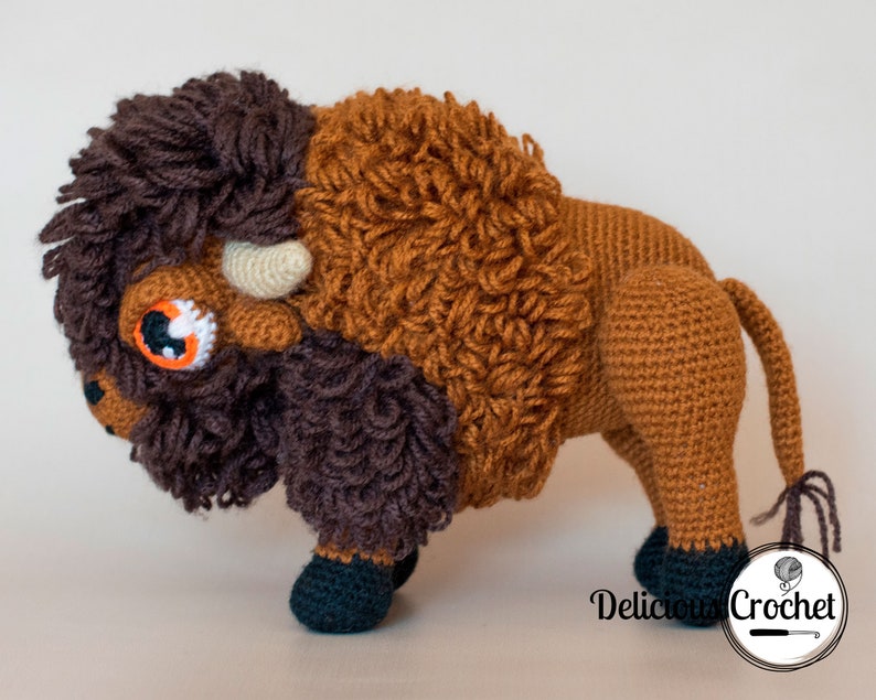 DeliciousCrochet American Bison (Buffalo). This is a crochet pattern, not the finished toy. Using DK or Sports acrylic yarn with a 2.5 mm hook, the toy stands 7.5 inches tall and 9 inches long. Instructions available in English (US) or Spanish.