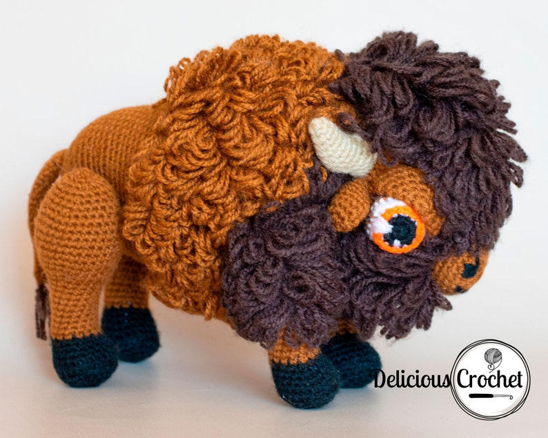 DeliciousCrochet American Bison (Buffalo). This is a crochet pattern, not the finished toy. Using DK or Sports acrylic yarn with a 2.5 mm hook, the toy stands 7.5 inches tall and 9 inches long. Instructions available in English (US) or Spanish.