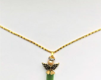 May include: A gold chain necklace with a green glass angel pendant. The angel has gold wings and a pearl and rhinestone halo.