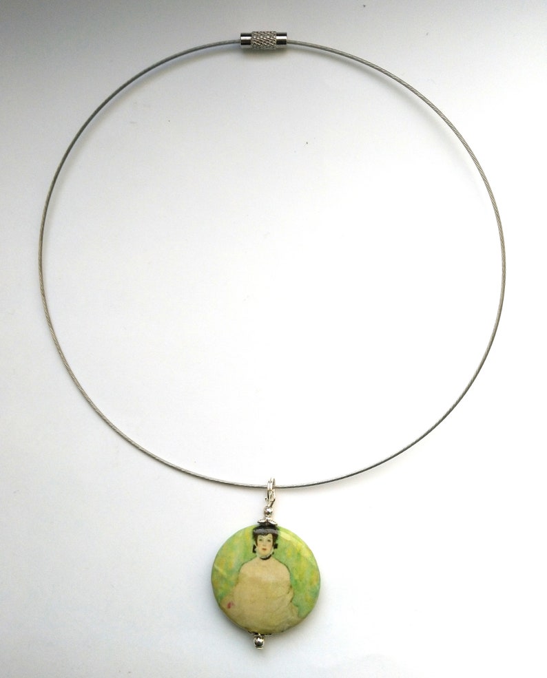 May include: A silver chain necklace with a round pendant featuring a painting of a woman in a green dress.