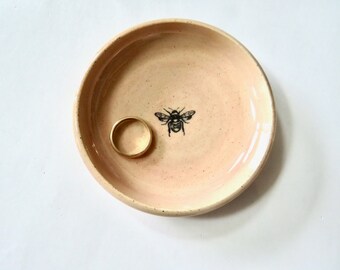 Pale peach pink ring dish with single bee