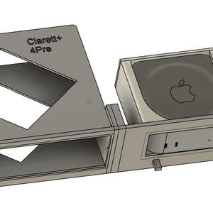 May include: A gray, 3D-printed rack mount with the text "NetworkBuck" and "Clarett+ 4Pro". The rack mount has a diamond-shaped cutout and a compartment for an Apple device. The design is for electronic equipment.