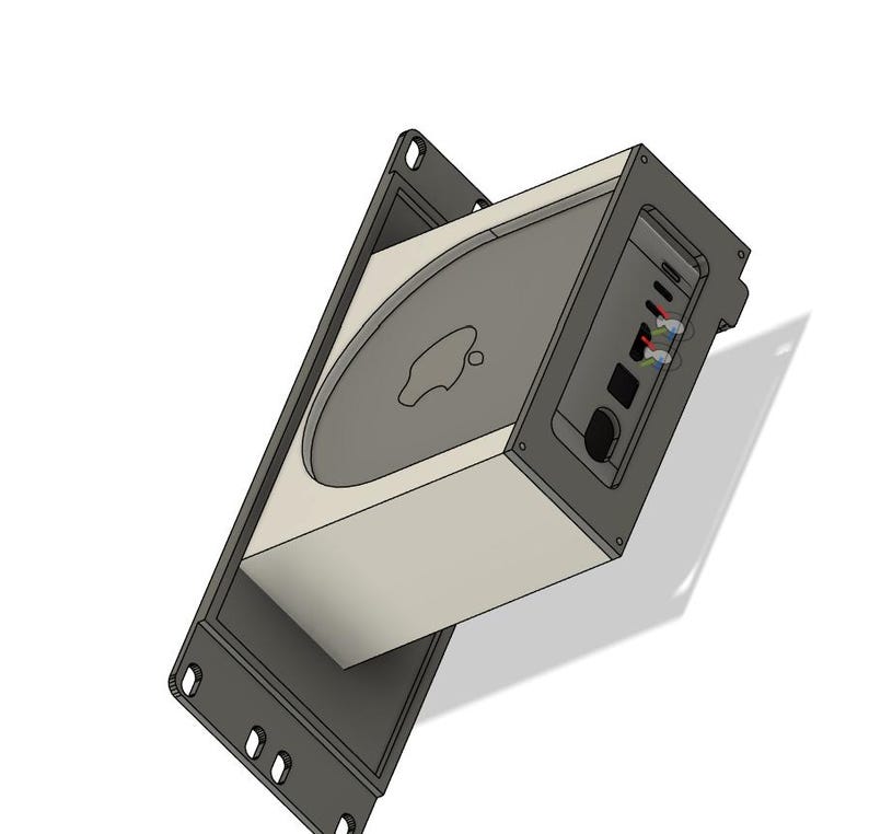 May include: A computer component with a light gray body and a dark gray face, featuring the Apple logo. The component is set within a dark gray frame with mounting holes. The side panel has ports and buttons.