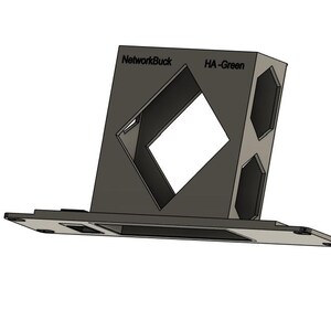 May include: A black and gray 3D printed stand with a diamond-shaped opening. The stand has the text "NetworkBuck" and "HA-Green" printed on it.