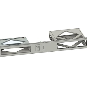 May include: A silver-colored rack mount component with geometric cutouts and the text "PANDUIT" on a rectangular section. The design includes multiple rectangular and triangular openings, suggesting a mounting or housing structure for electronic equipment.