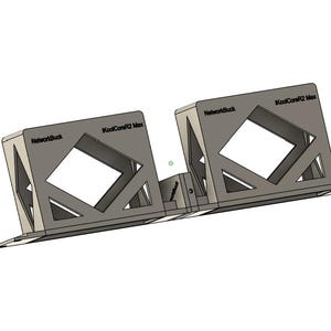 Puede incluir: Estructura geométrica gris con texto "NetworkBuck" y "KoolCoreR2 Max". El diseño presenta formas de diamante abiertas y soportes angulados, sugiriendo un producto funcional, posiblemente industrial.