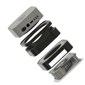 May include: A disassembled view of a black and gray electronic device with a fan and multiple components. The device has a power cord and several ports.