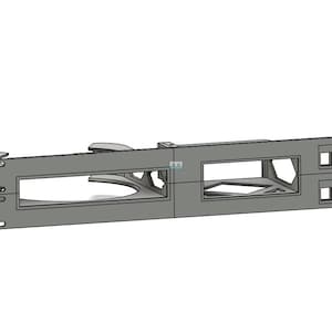 May include: A grey metal rack mount component with rectangular openings and mounting holes. The component has a geometric design with cutouts and appears to be for electronic equipment. The design is modern and industrial.