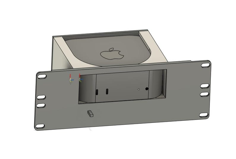 May include: A gray rack mount enclosure with a recessed area for a small computer. The computer has the Apple logo on top. The enclosure has several mounting holes and a rectangular opening for the computer's ports.