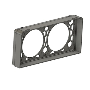 May include: A gray rectangular frame with two large circular openings and a honeycomb pattern on the sides. The frame has a series of small holes and a cylindrical projection on the side. The object is set against a white background.