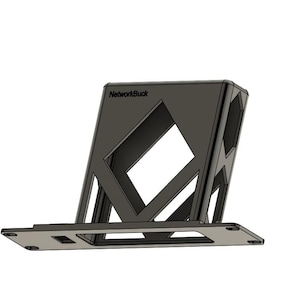 May include: A dark gray, geometric laptop stand with the text "NetworkBuck" on the top. The stand has a rectangular base and a slatted, angled support structure with diamond-shaped cutouts. The design is modern and minimalist.