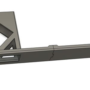 May include: A gray metal NetworkRack with the text "NetworkRack" printed on the side. The rack has a rectangular opening in the front and a long, flat section extending to the right.