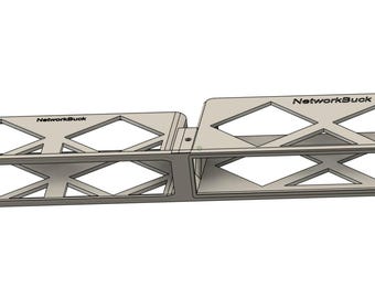 May include: A silver-colored rack mount with two sections, each featuring a diamond-patterned design. The text "NetworkBuck" is printed on the top of each section. The rack mount is designed for network equipment.
