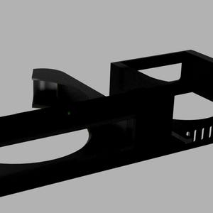May include: A black metal rack mount component with curved and rectangular sections. It features multiple holes and slots for mounting and cable management. The design is modern and industrial.