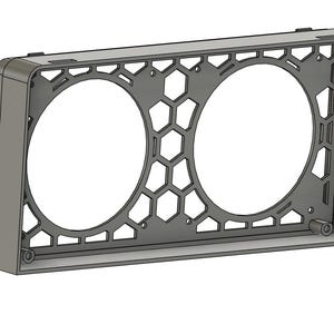 May include: A gray, rectangular frame with two large circular openings. The center features a honeycomb pattern. The frame is likely designed to house or mount circular components, such as fans or speakers. The design is modern and geometric.