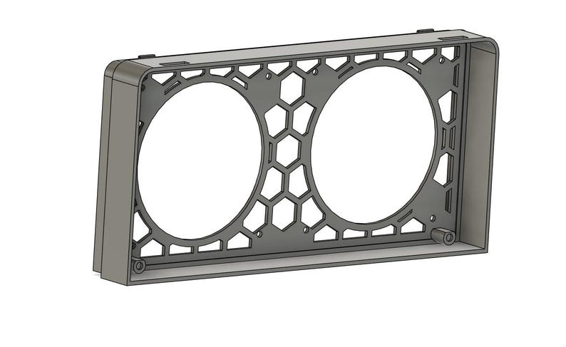 May include: A gray, rectangular frame with two large circular openings. The center features a honeycomb pattern. The frame is likely designed to house or mount circular components, such as fans or speakers. The design is modern and geometric.