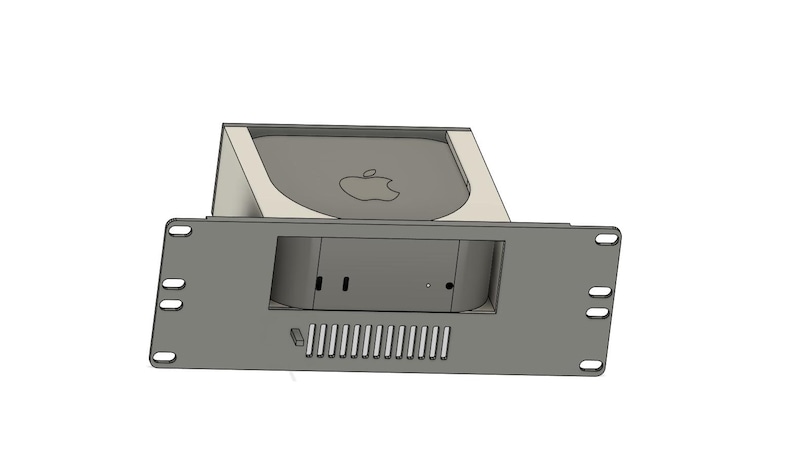 May include: A gray computer rack mount designed to hold a small computer. The rack has a rectangular shape with a series of ventilation slots and mounting holes. The Apple logo is visible on the computer.